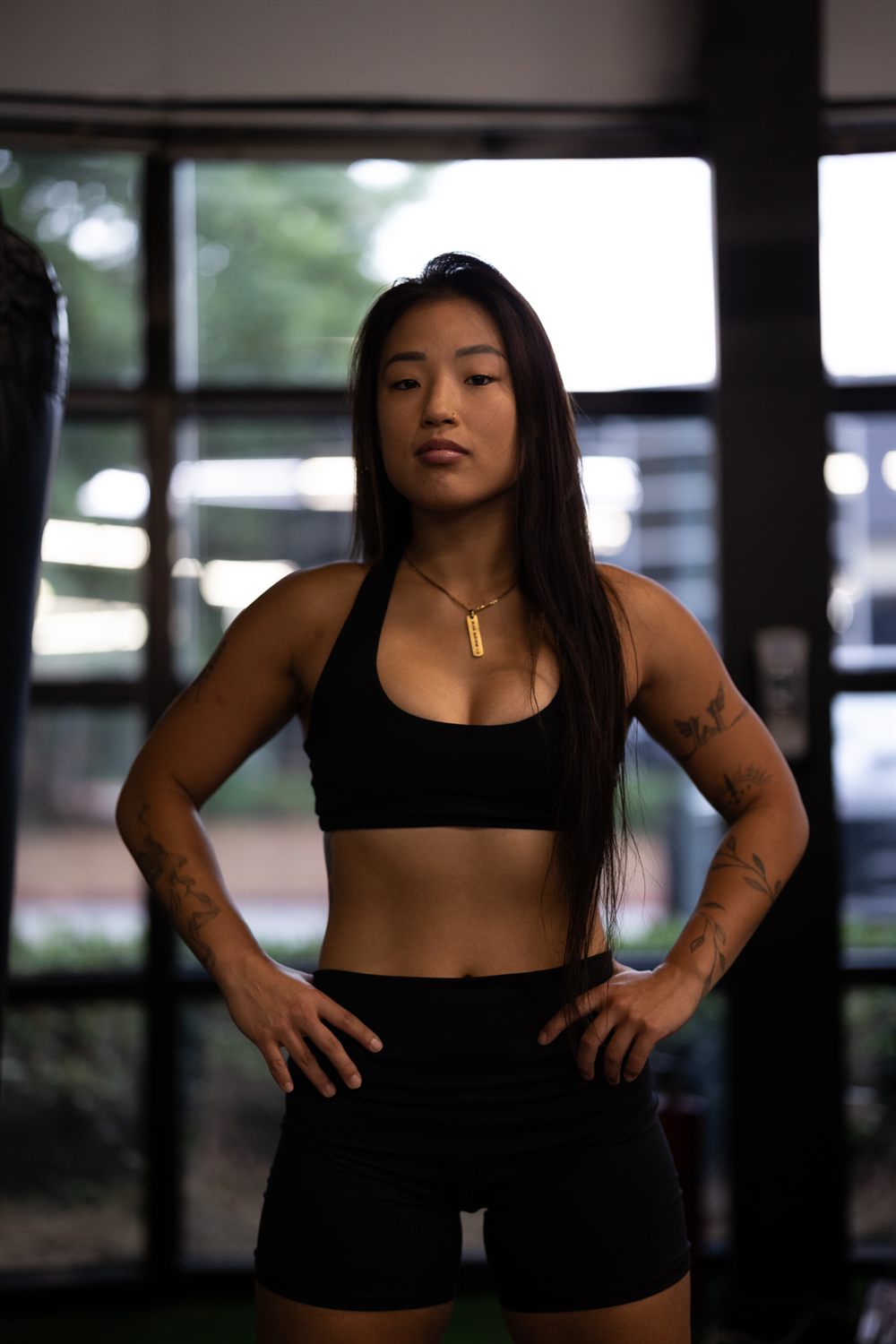 Cass standing in the gym, hands on hips